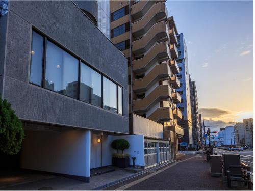 a building on the side of a city street at THE HOTELS HAKATA KASANE Bayside in Fukuoka