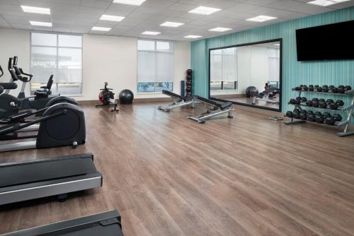 a gym with treadmills and exercise equipment and a large mirror at Holiday Inn Express & Suites - Odessa I-20 by IHG in Odessa