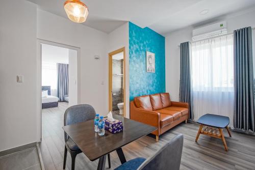 a living room with a couch and a table at Jomo in Ho Chi Minh City