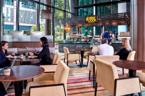 a group of people sitting at tables in a restaurant at Holiday Inn Express Singapore Clarke Quay by IHG in Singapore