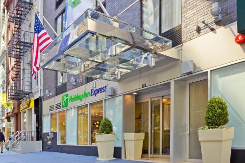 a store front of a building with an american flag at Holiday Inn Express - Wall Street by IHG in New York