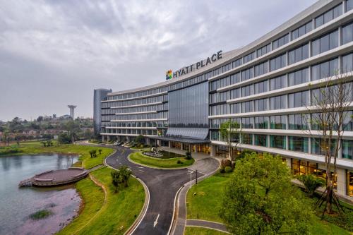 an office building with a river in front of it at Hyatt Place Changsha Airport in Changsha
