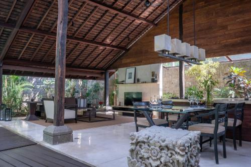 
a living room filled with furniture and a patio at Ametis Villa in Canggu
