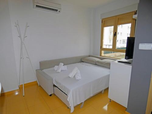 a bedroom with a bed and a television and a window at Anacasa Avinyo Sector 5 AP121 in Oliva
