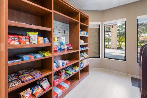 a pantry with wooden shelves filled with food at Holiday Inn Express Naperville by IHG in Naperville