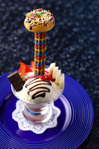 a plate with a dessert with a donut on a stick at LEGOLAND Japan Hotel in Nagoya