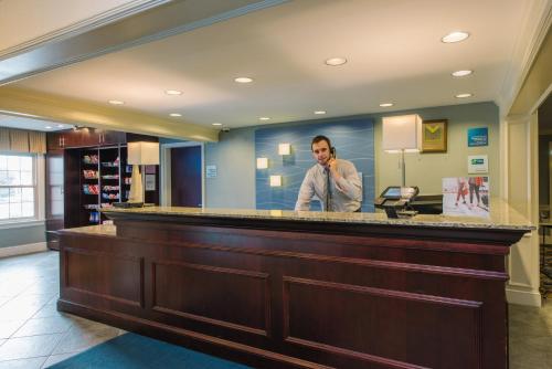 a man talking on a cell phone at a bar at Holiday Inn Express and Suites Merrimack by IHG in Merrimack