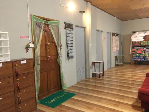 a room with a closet and a door and a floor at Thong Family Homestay Chiangdao in Chiang Dao