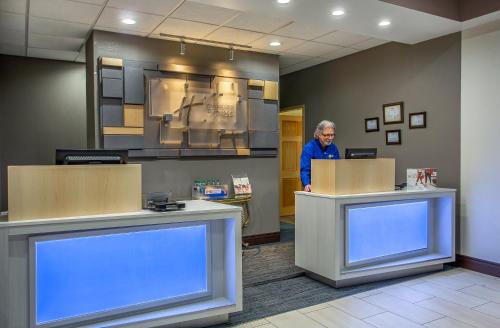 a man standing at a counter in a waiting room at Holiday Inn Express & Suites Morristown by IHG in Morristown