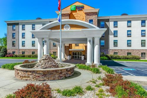 a hotel building with a fountain in front of it at Holiday Inn Express & Suites Morristown by IHG in Morristown