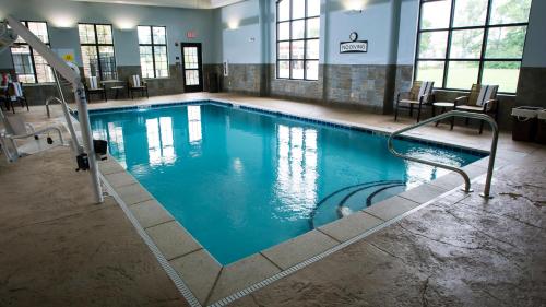 a large swimming pool with blue water in a building at Staybridge Suites Lexington, an IHG Hotel in Lexington