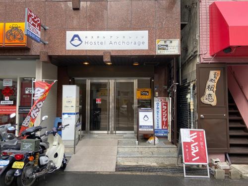 a motorcycle parked in front of a building at Hostel Anchorage in Kobe