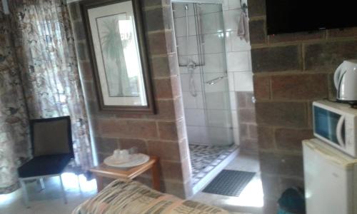 a bathroom with a shower in a room at Lothian rd Cottage in Durban
