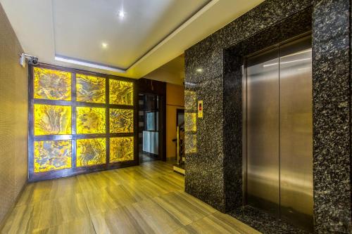 an elevator lobby with a door and a window at Treebo Shivani in Indore