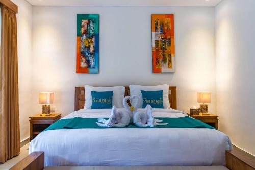 two stuffed animals are sitting on a bed at The Pesaren Ubud in Ubud