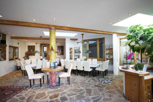 a dining room with a table and white chairs at EL MOLINO - ehemalige Mühle mit großem Gartenareal in Modlisch