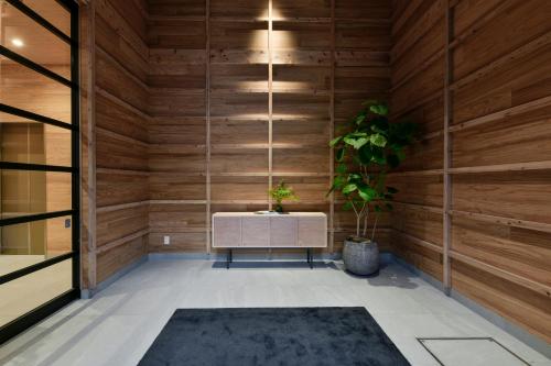 a sauna with a bench and a plant at REF Kumamoto by VESSEL HOTELS in Kumamoto