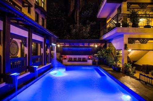 a swimming pool in the middle of a building at night at The King Post in Nairobi