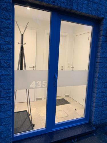 a window of a building with a windmill behind it at Terrasses de Malmedy Connecto Duplex 435 & 436 en Studio 336 in Malmedy