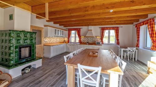 a large kitchen with a wooden table and chairs at chalupa Kristina u Adršpachu in Teplice nad Metují