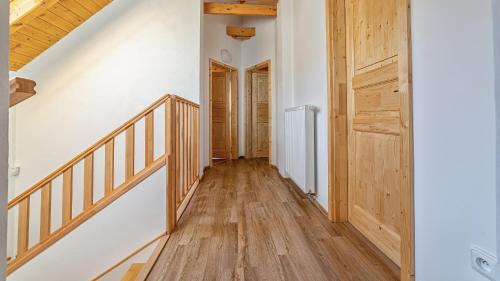 a hallway with a wooden staircase and wooden floors at chalupa Kristina u Adršpachu in Teplice nad Metují