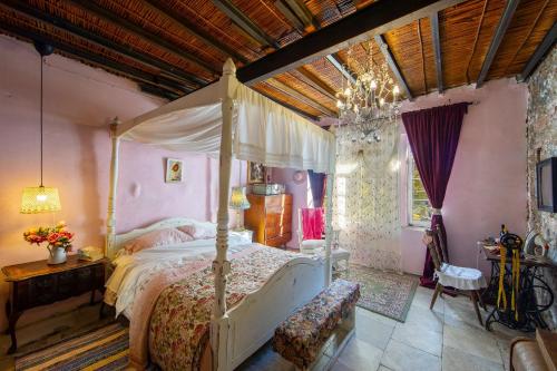 a bedroom with a canopy bed and a chandelier at Tina's Country Home in Askas