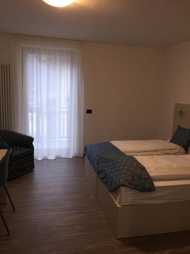 Ένα ή περισσότερα κρεβάτια σε δωμάτιο στο MOUNTAIN RESORT Appartamenti