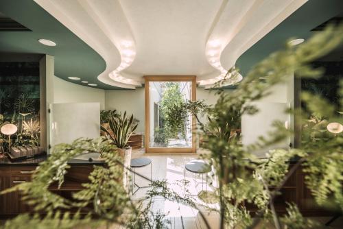 a room with plants on the ceilings and a window at Stock Resort in Finkenberg