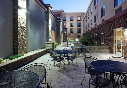 a patio with tables and chairs in a courtyard at Holiday Inn Express & Suites Aberdeen by IHG in Aberdeen