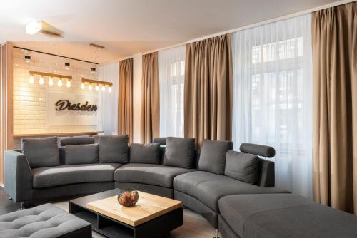 a living room with a couch and a table at ibis Styles Dresden Neustadt in Dresden