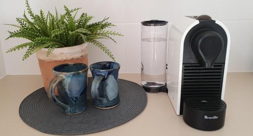 two blue vases on a counter next to a toaster at Fechner Place Barossa, 1 Bed, Wine & Platter in Tanunda