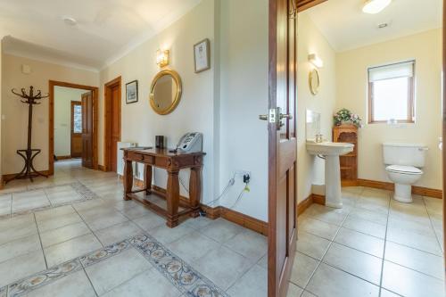 a bathroom with a sink and a toilet at Webbs Retreat in Wadebridge