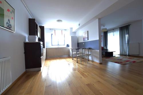a living room with a kitchen and a dining room at Upground Residence Apartments in Bucharest