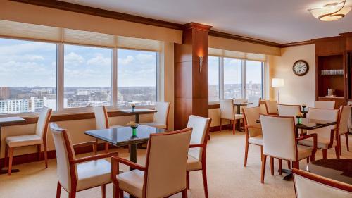 a restaurant with tables and chairs and windows at InterContinental Cleveland by IHG in Cleveland