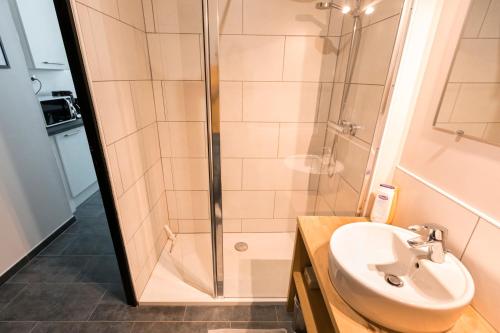 a bathroom with a shower and a sink at Au détour des Places in Arras