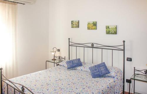 a bedroom with a bed with blue pillows on it at Agriturismo Mannaioni in Volterra