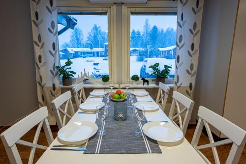 a dining room with a table and a window at Romme stugby in Borlänge