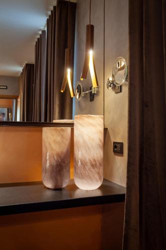 two towels sitting on a counter in a bathroom at Asiago Sporting Hotel & Spa in Asiago