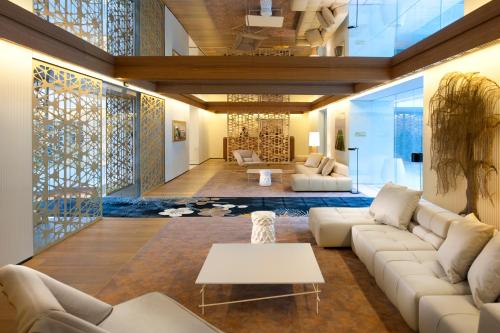 a living room with white couches and a table at Mandarin Oriental, Barcelona in Barcelona
