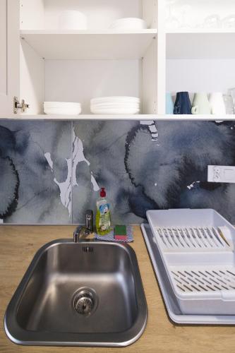 a kitchen counter with a sink in a kitchen at White Home Room in Białystok