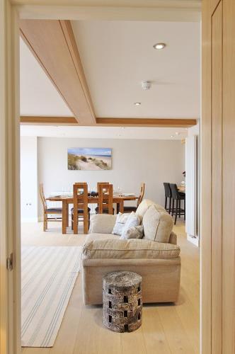 a living room with a couch and a table at Goose's Getaway in Wells next the Sea