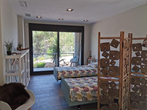 a room with a bedroom with a bed and a window at Casa de la Luz in Sa-Riera