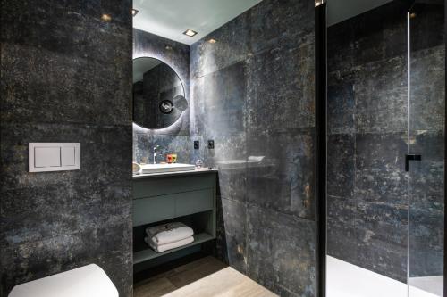 a bathroom with a sink and a shower at Chalets Izia - Village Montana in Val dʼIsère