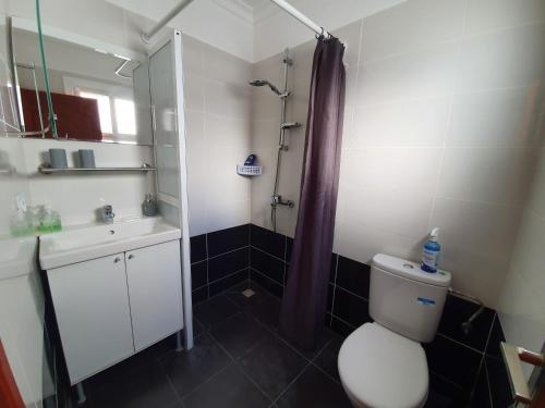 a bathroom with a toilet and a sink and a shower at APARTMENT AYOUB -for families only- in Nador