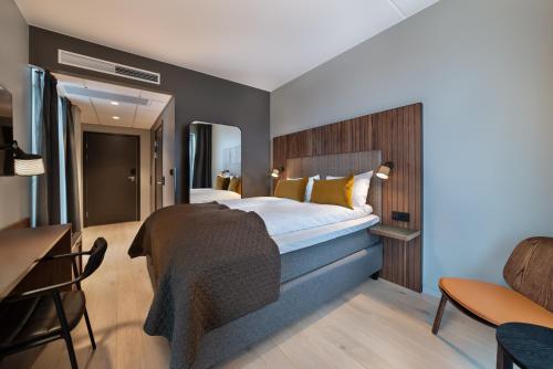 a hotel room with a bed and a desk at Quality Hotel River Station in Drammen