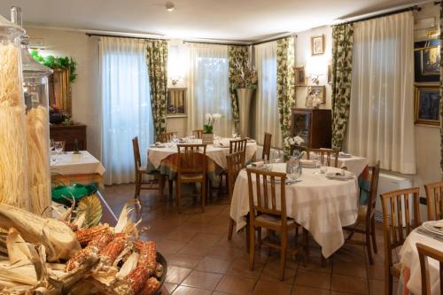 a restaurant with tables and chairs in a room at Hotel Locanda Al Sole in Castello di Godego