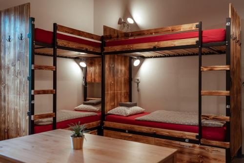 two bunk beds in a room with a table at Turn Hostel in Ljubljana