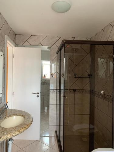 a bathroom with a shower and a sink at Recanto da Sol in Florianópolis