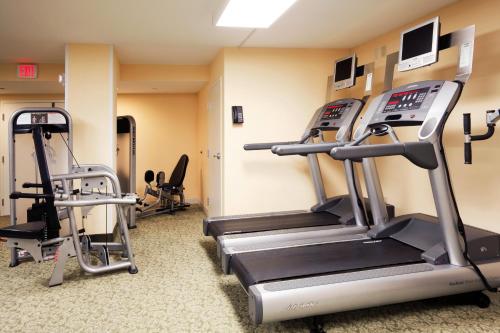 a gym with treadmills and ellipticals in a room at Holiday Inn & Suites Clearwater Beach by IHG in Clearwater Beach