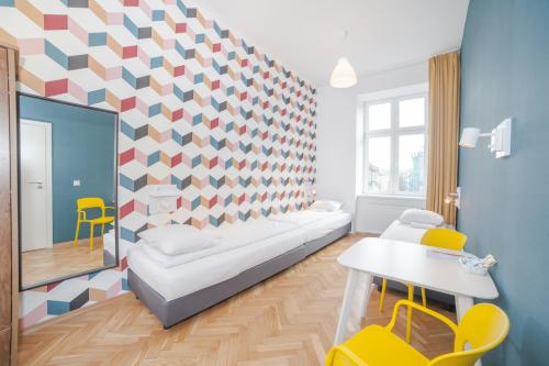 a living room with a couch and a geometric wall at Atlantis Hostel in Kraków